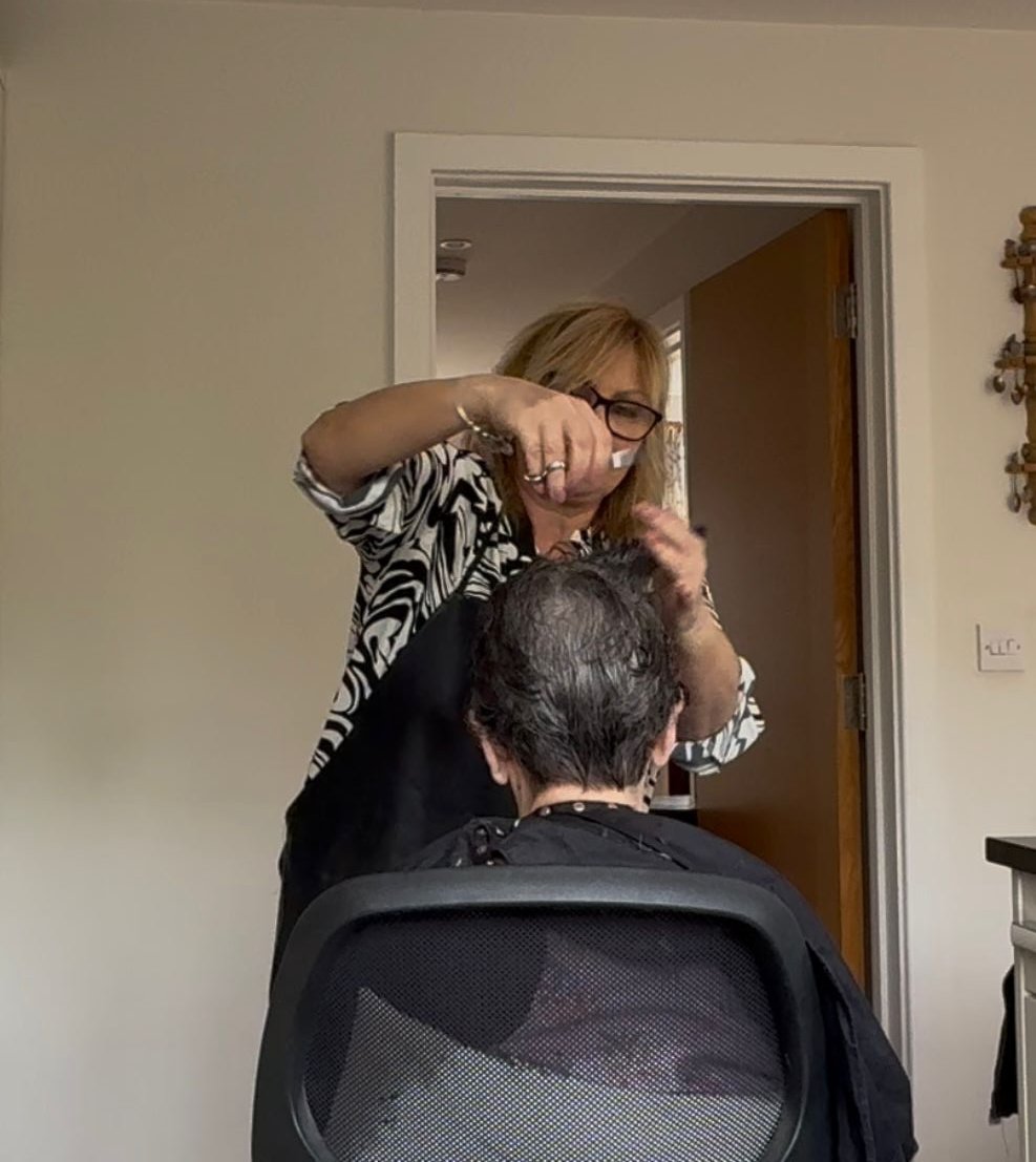 Cheryl cutting a client's hair at their home in Tunbridge Wells
